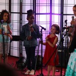 young vocal Students from World Heart Beat Music Academy in London performing for an audience