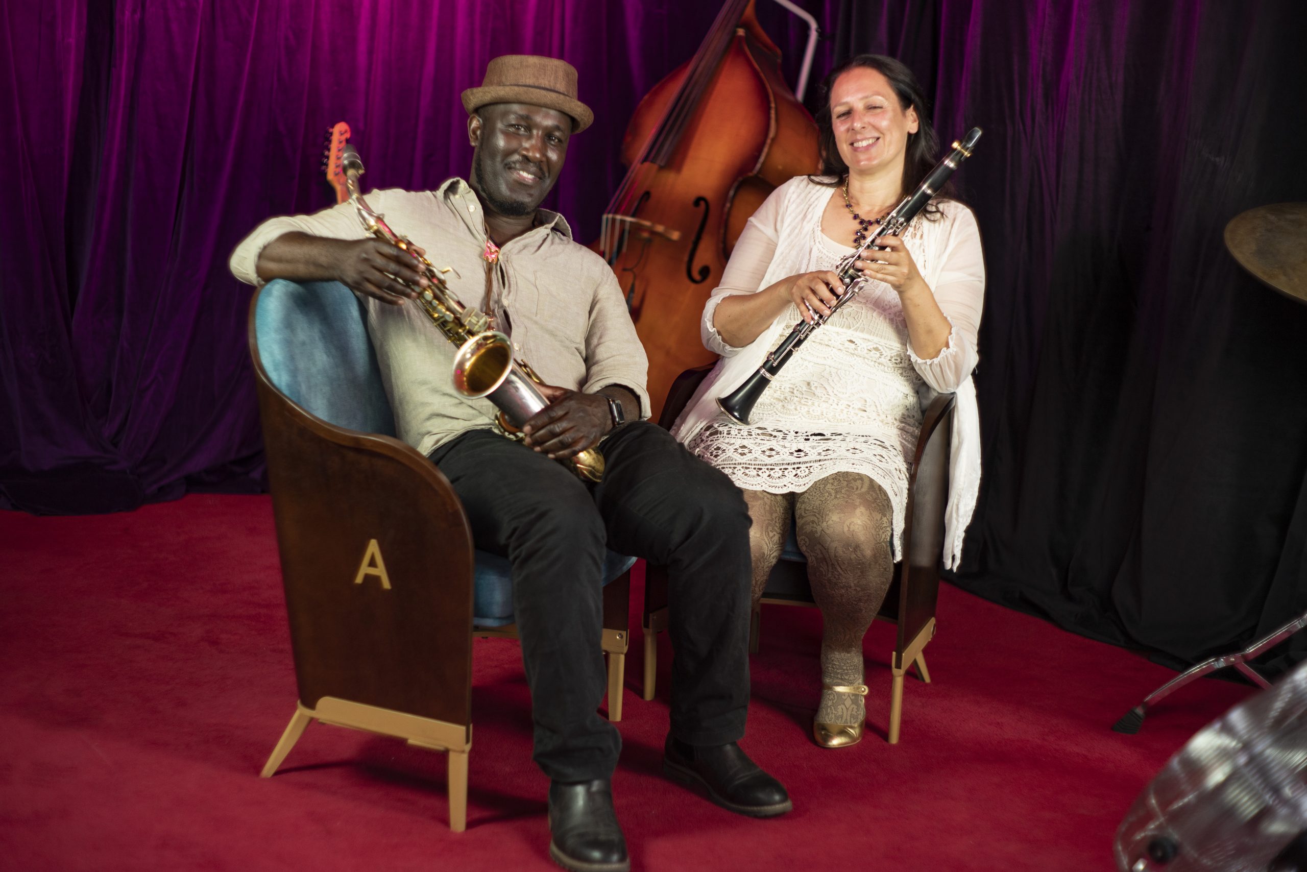 Name a seat - artistic director Sahana Gero and Tony Kofi, music and whb tutor, seated on samples of the new auditorium seating