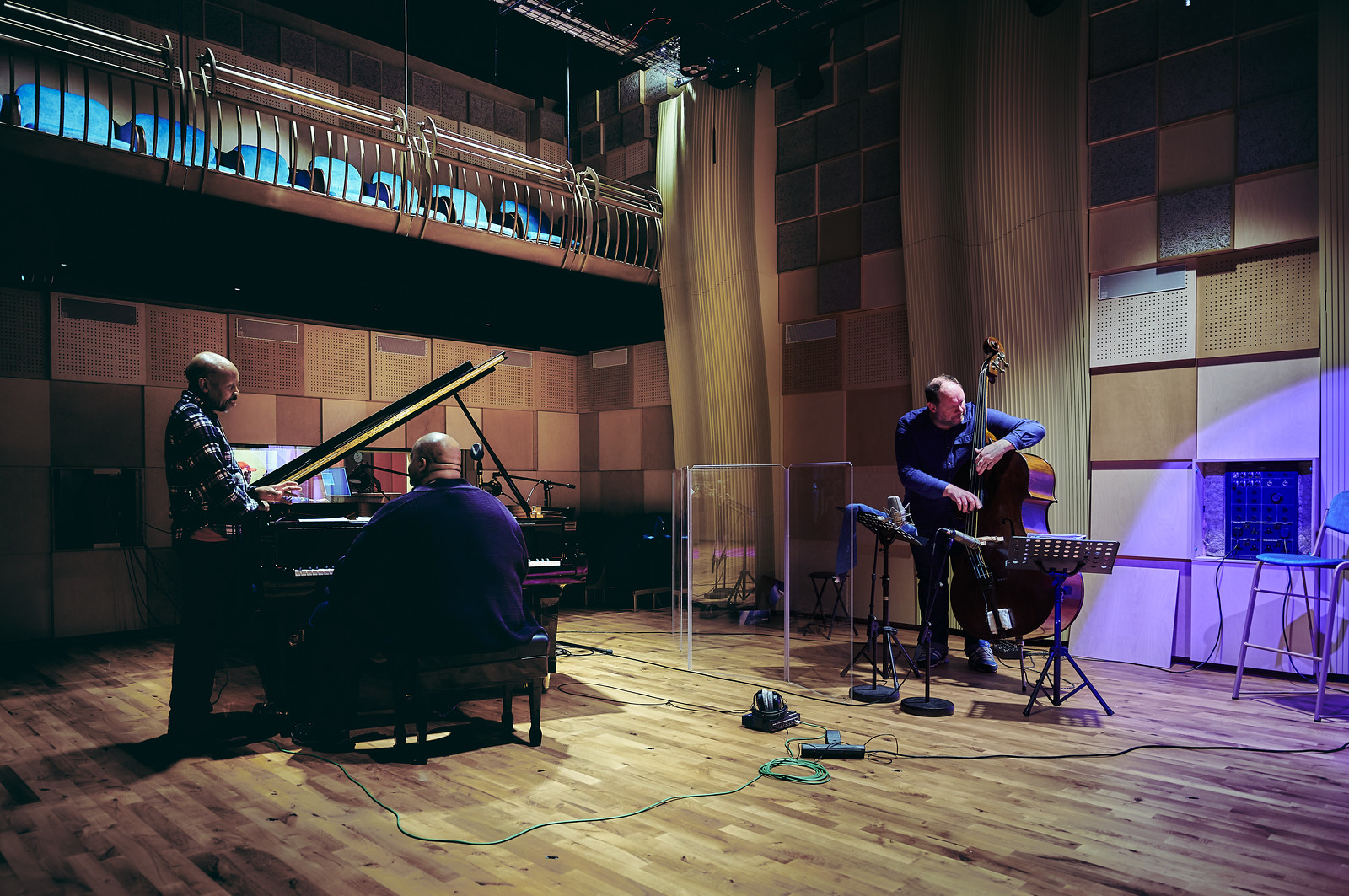 Three musicians in a recording session in the concert hall