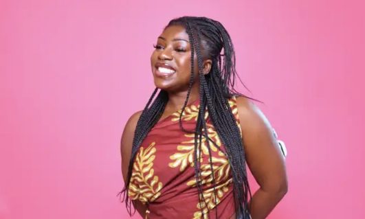 Alexandra Ampofo portrait on pink background.