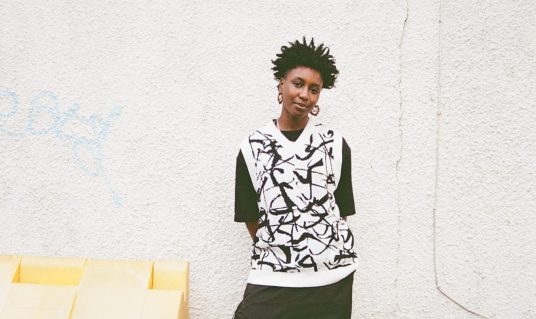 Damali full portrait against urban wall.