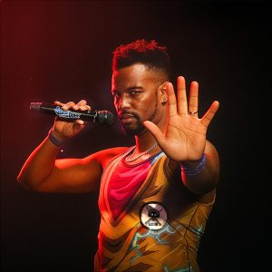 Shao Dow holding microphone press photo