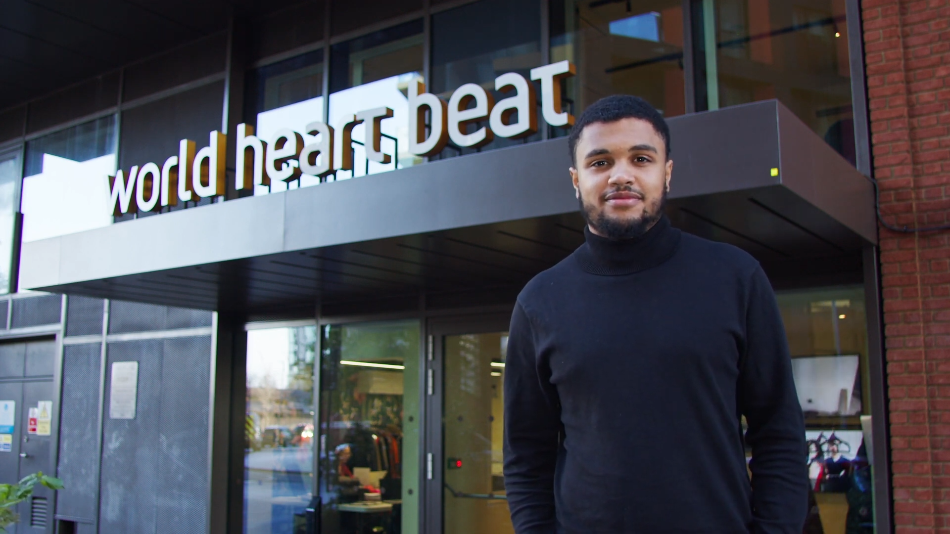 Callum in front of the World Heart Beat Embassy Gardens building