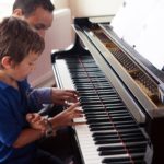 A young student enjoys Piano Lessons in Wandsworth, SW London