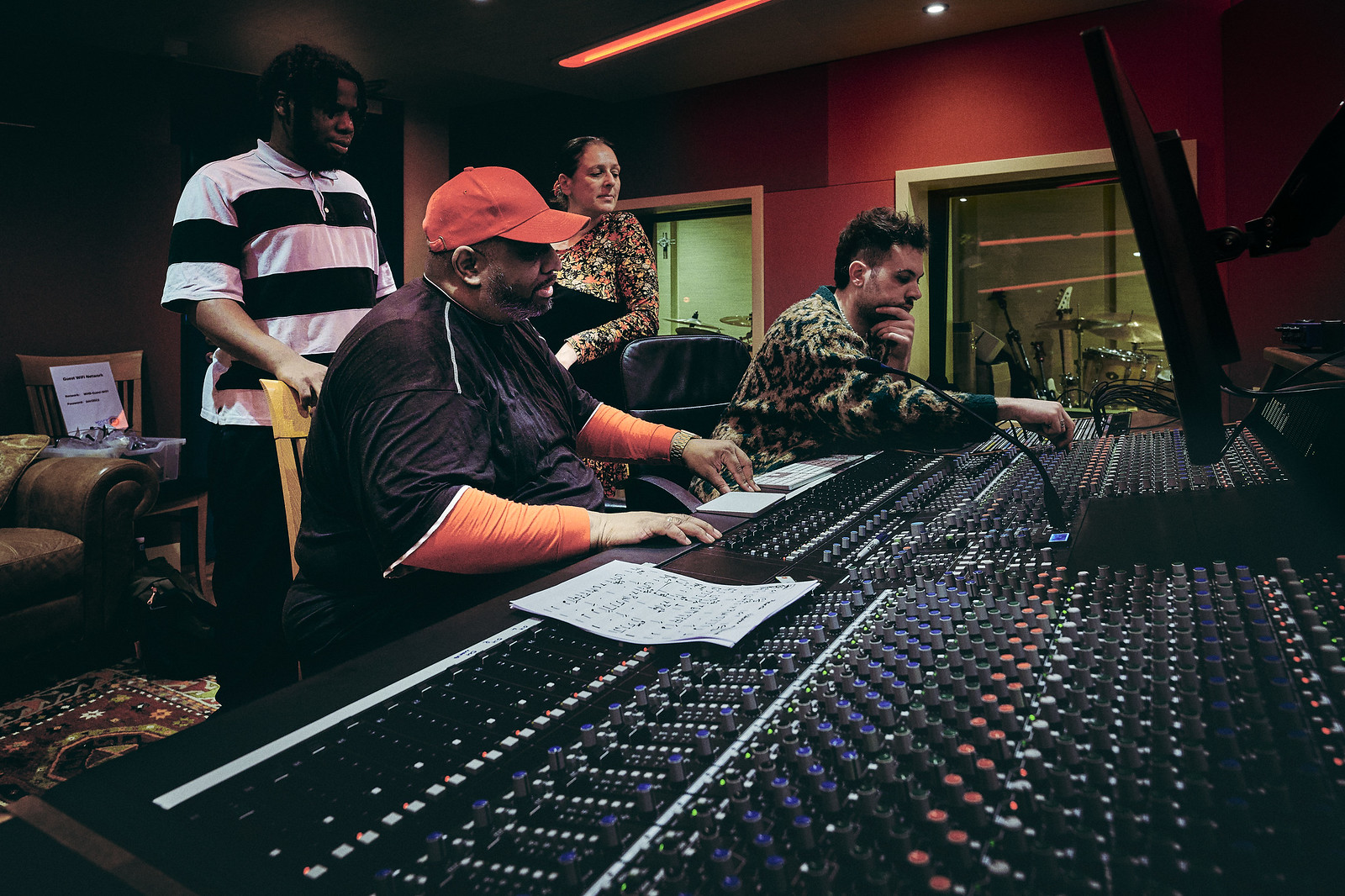 A group of producers working at a sound mixing desk